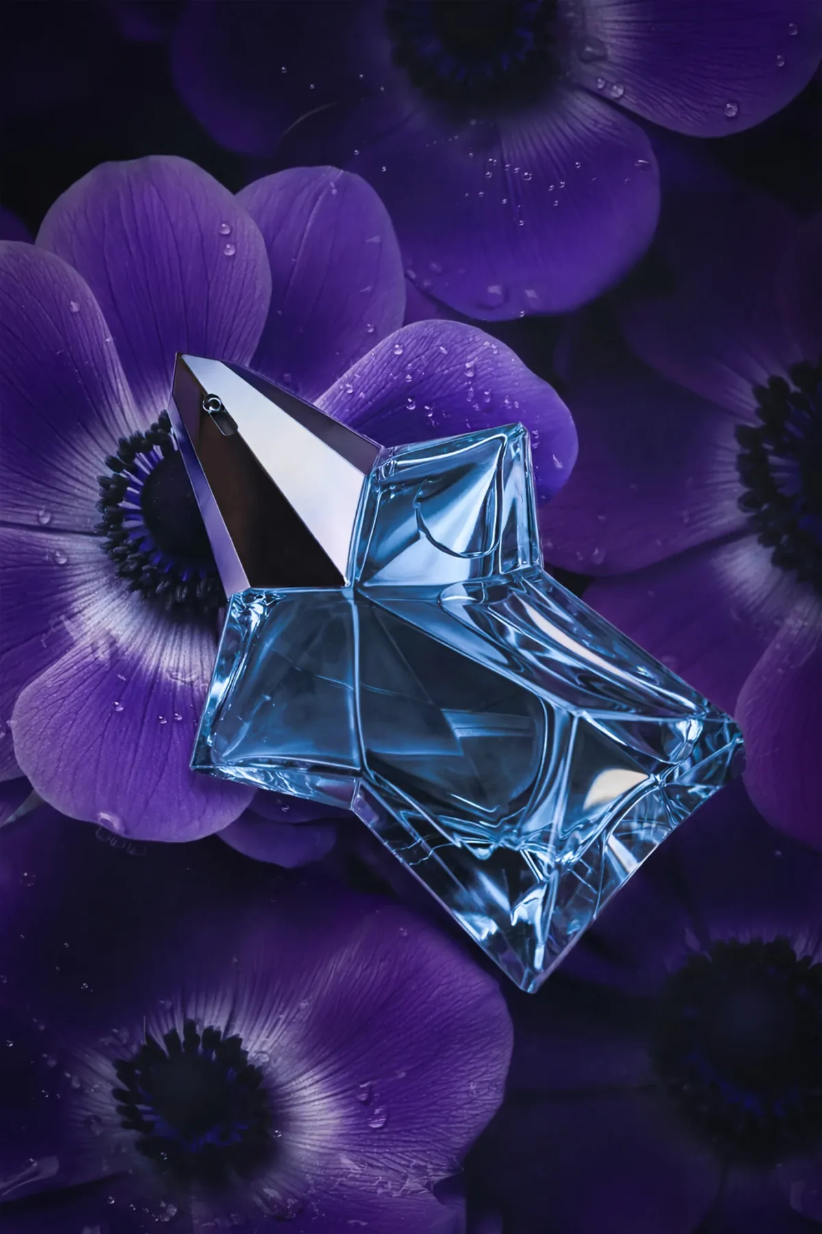 Mugler Angel perfume bottle surrounded by purple flowers