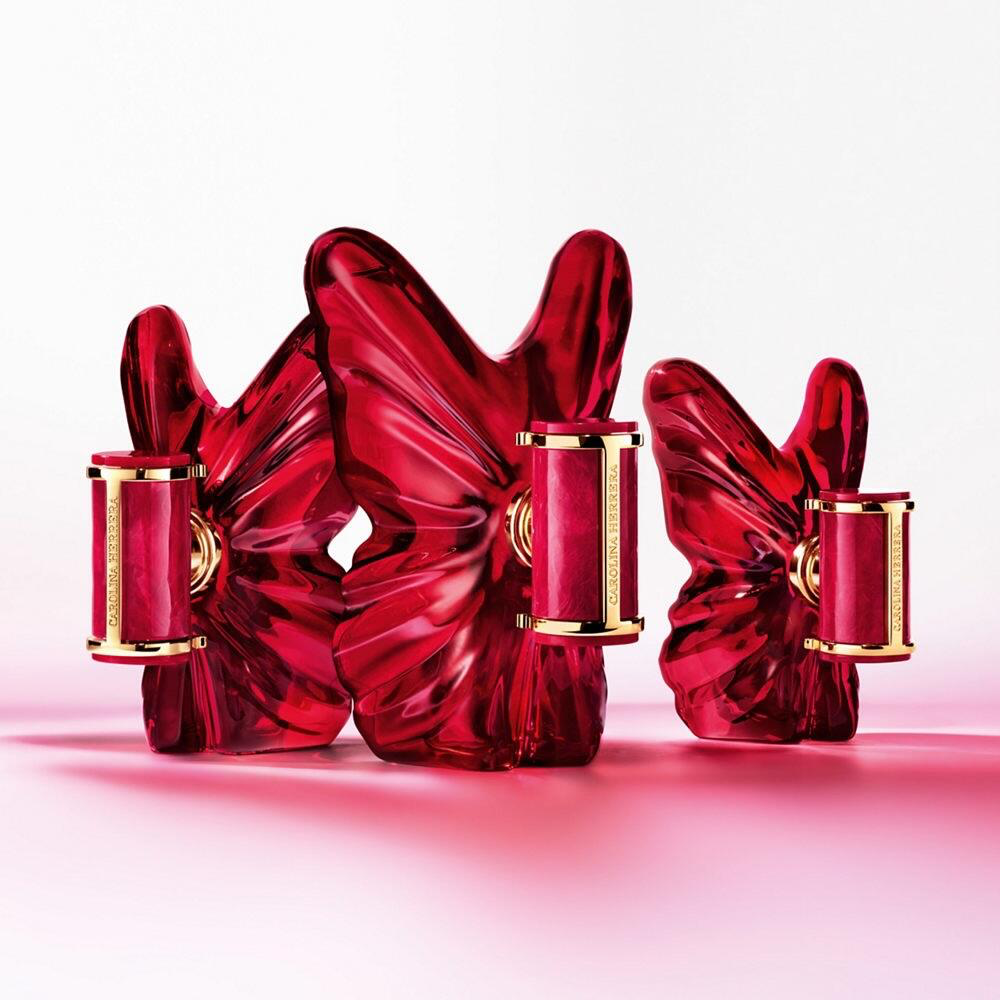 Three La Bomba Intensa Carolina Herrera bottles in the new berry-red butterfly design