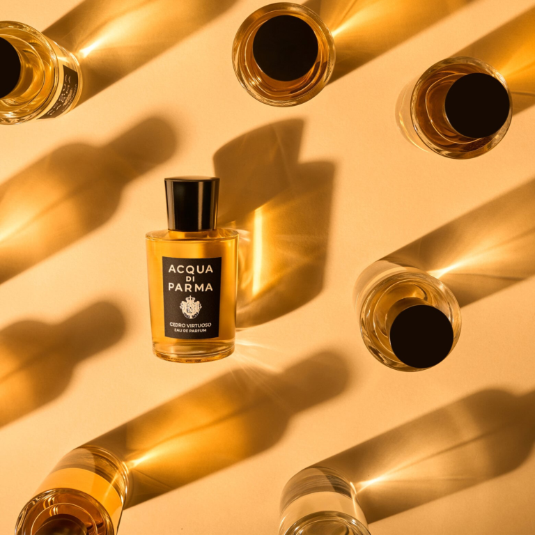 Acqua di Parma Cedro Virtuoso bottles arranged in golden light and geometric shadows