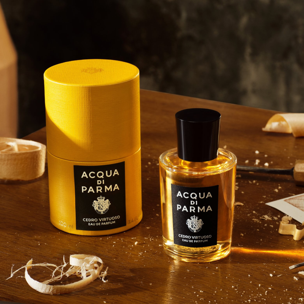 Acqua di Parma Cedro Virtuoso bottle and yellow presentation box on a wooden workbench