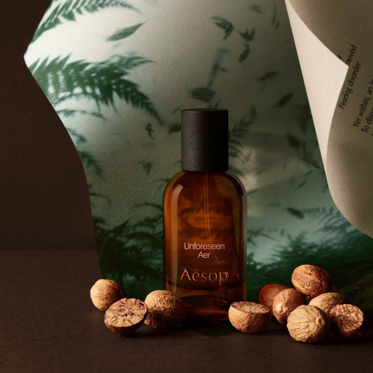 Aesop Unforeseen Aer bottle surrounded by nutmeg, a key note in the fragrance