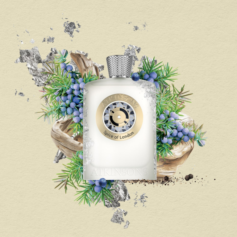 Atkinsons Spice of London frosted bottle surrounded by juniper berries and wood.