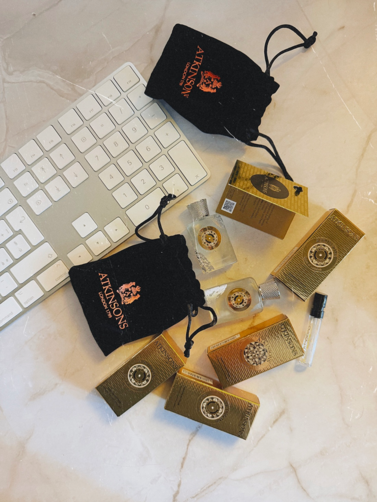 Atkinsons Spice of London review samples and miniatures beside a computer keyboard.