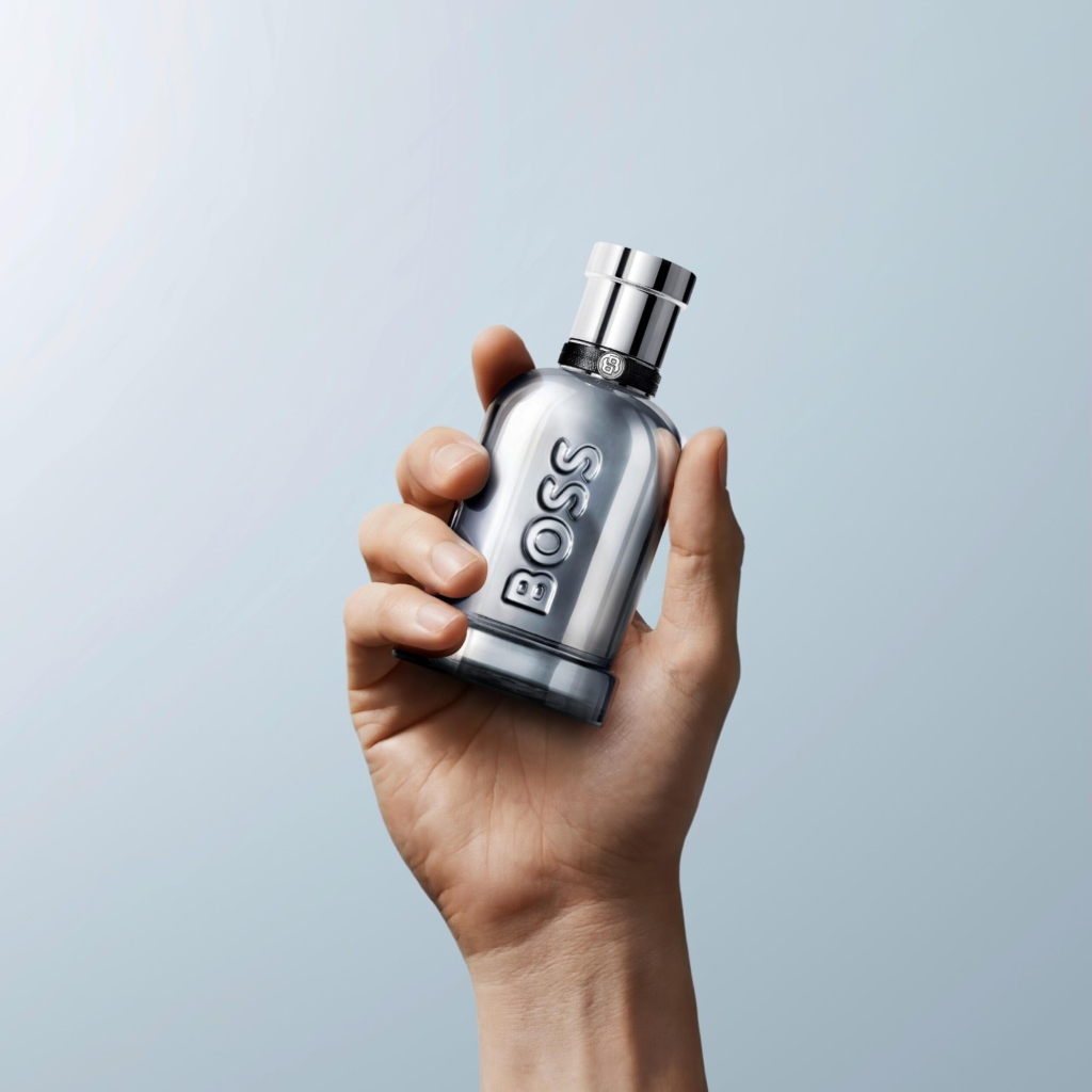 BOSS Bottled Beyond Intense silver fragrance bottle held in one hand