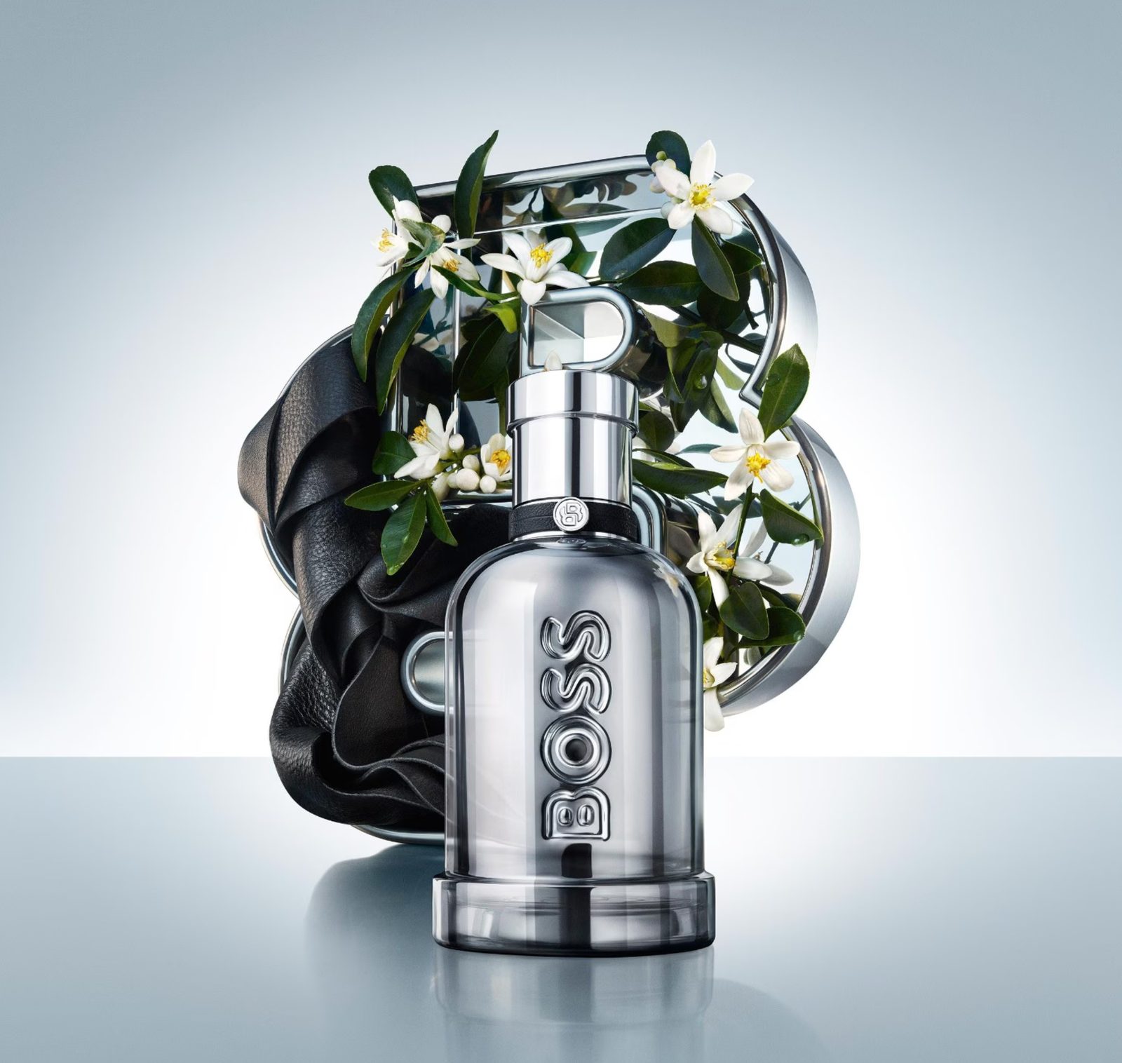 BOSS Bottled Beyond Intense bottle with orange blossom flowers and black leather