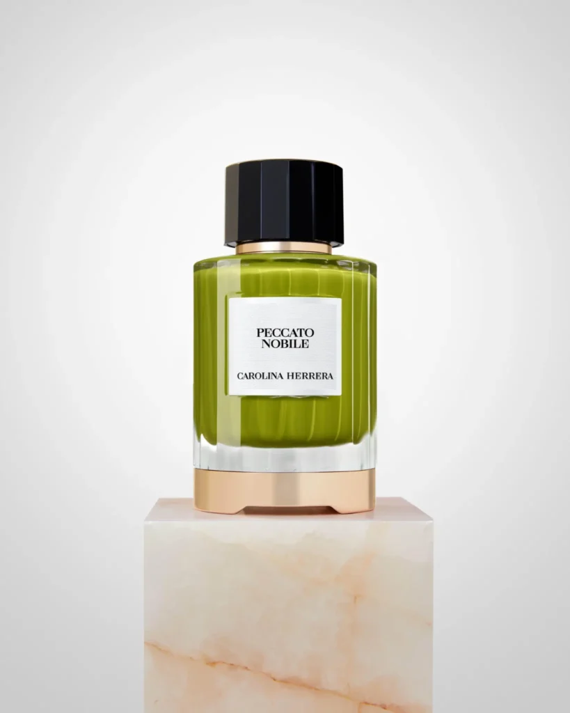 Carolina Herrera Peccato Nobile green bottle on a stone pedestal