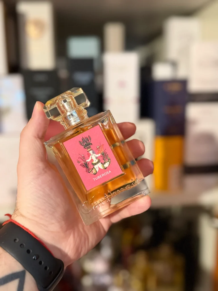 Carthusia Tuberosa Eau de Parfum bottle held in hand inside a perfume store