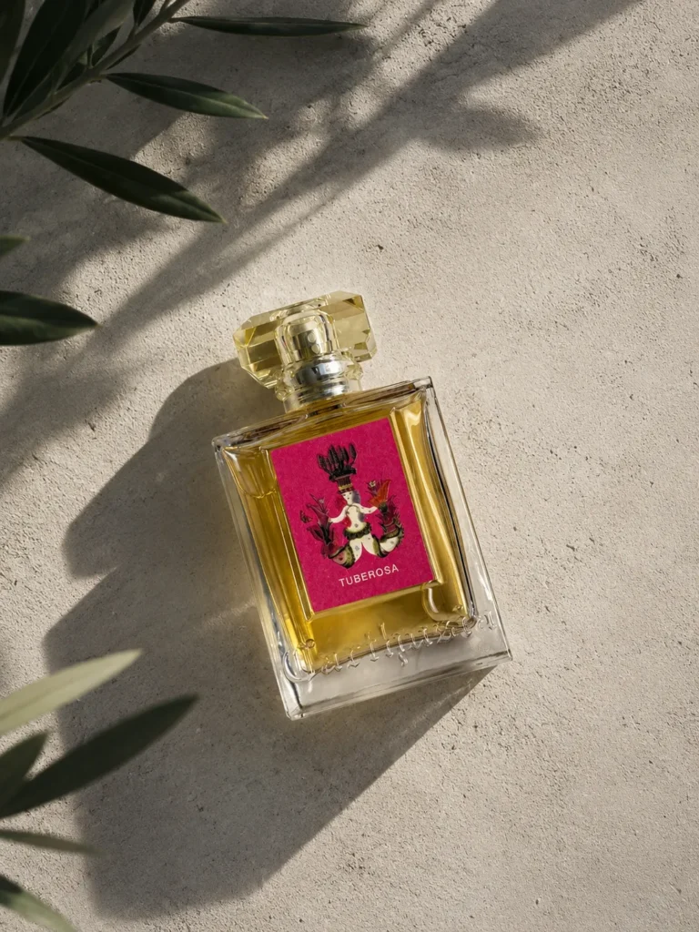 Carthusia Tuberosa Eau de Parfum bottle on a textured stone surface in warm sunlight