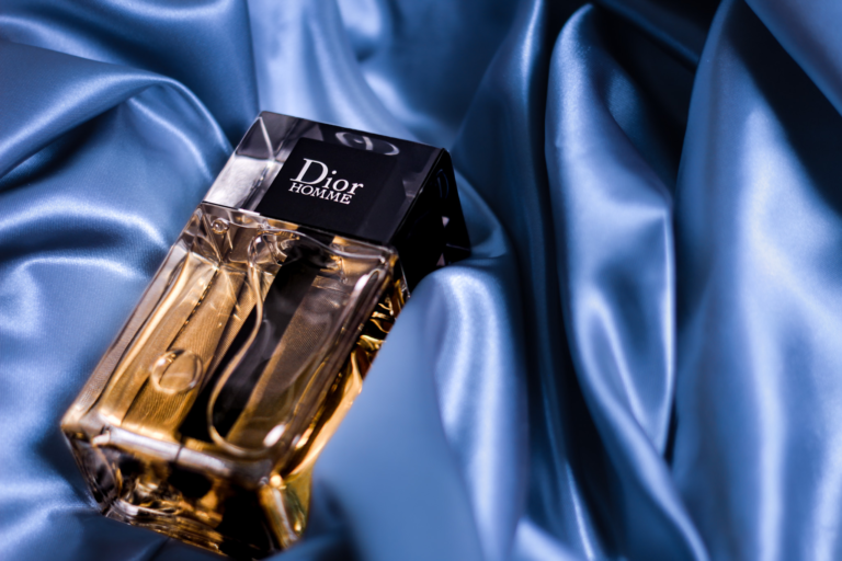 Dior Homme history represented by a bottle resting on blue satin