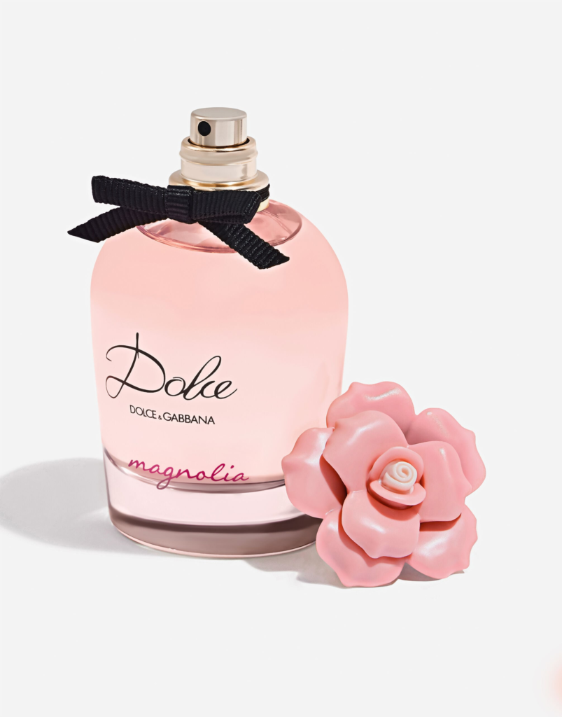 Dolce & Gabbana Dolce Magnolia Eau de Parfum bottle at an angle beside a pink flower detail