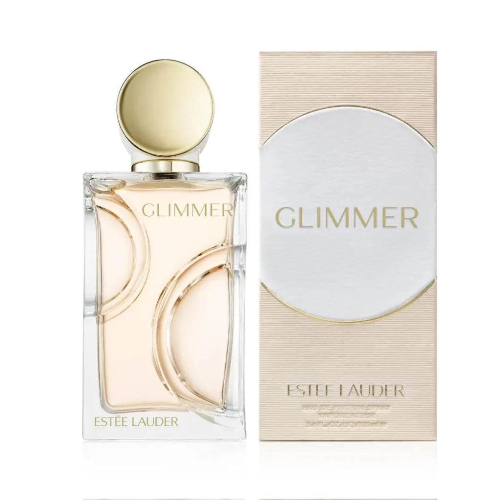 Estée Lauder Glimmer perfume bottle beside its cream and gold presentation box