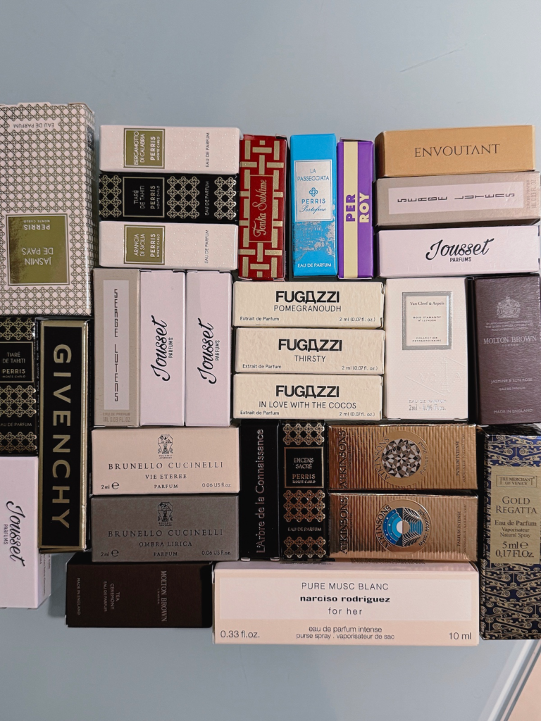 Flat lay of dozens of niche perfume sample boxes from Perris Monte Carlo, Jousset Parfums, Fugazzi, Brunello Cucinelli and Atkinsons