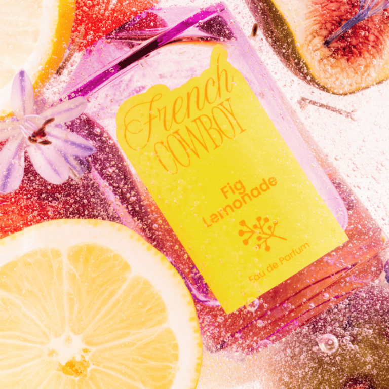 French Cowboy perfumes Fig Lemonade bottle submerged with lemon, figs and white flowers