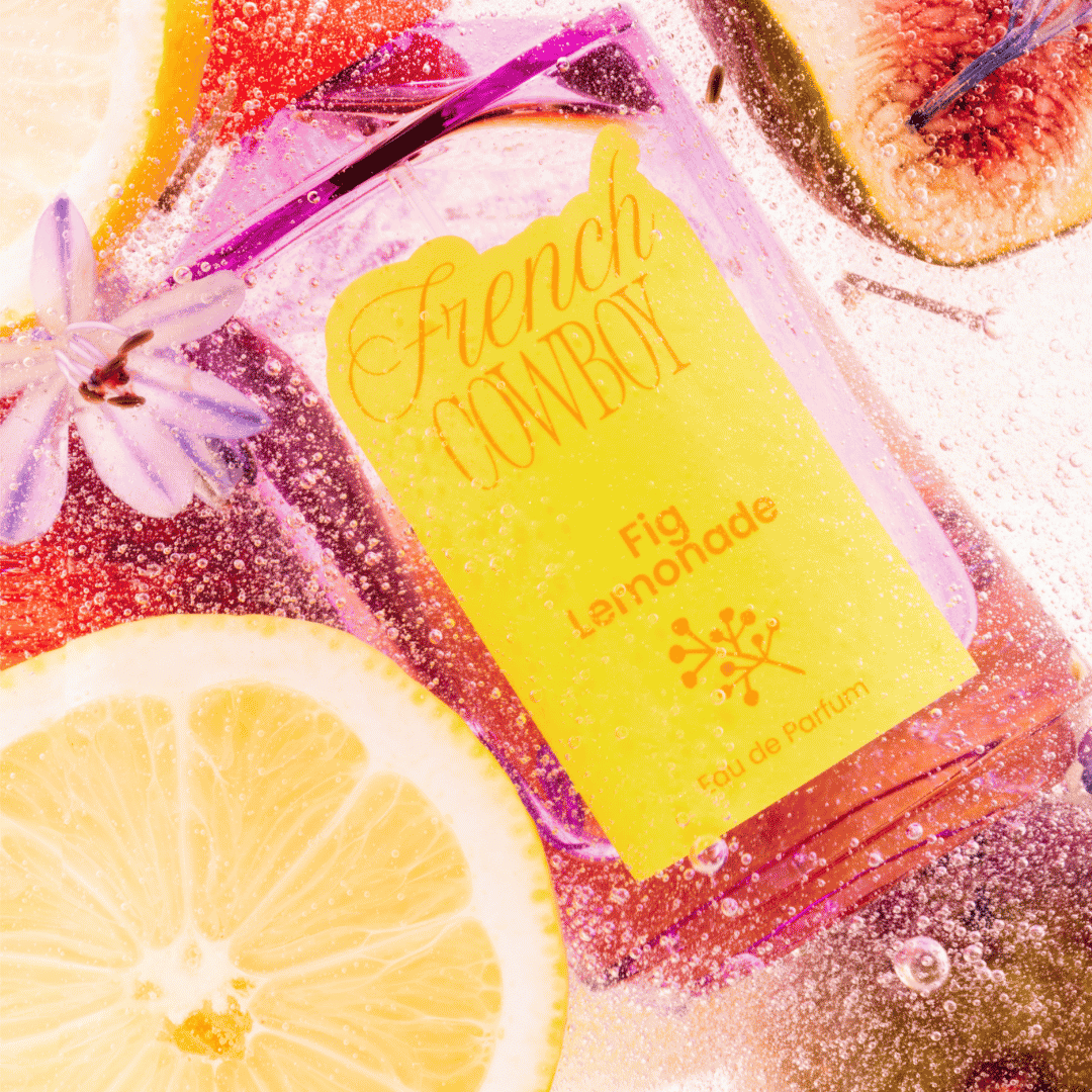 French Cowboy perfumes Fig Lemonade bottle submerged with lemon, figs and white flowers