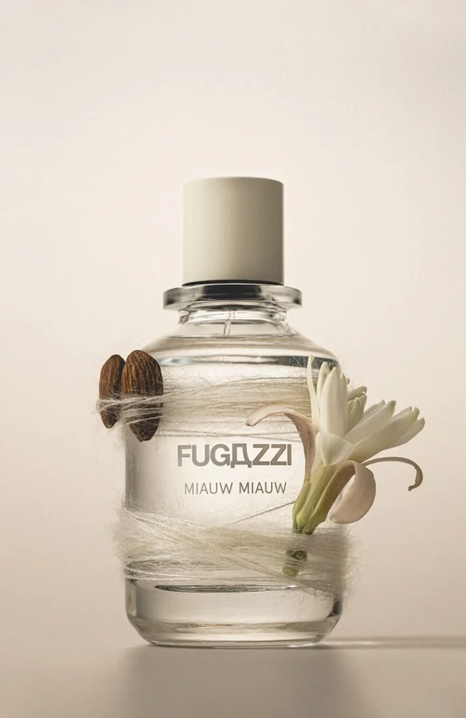 Fugazzi Miauw Miauw bottle styled with almonds, white flowers and soft fibres.