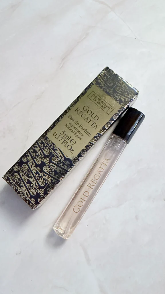 Gold Regatta 5 ml perfume sample by The Merchant of Venice next to its box