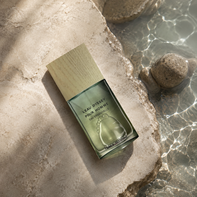 Issey Miyake L’Eau d’Issey Pour Homme Eau Essentielle bottle beside clear water and pale rocks