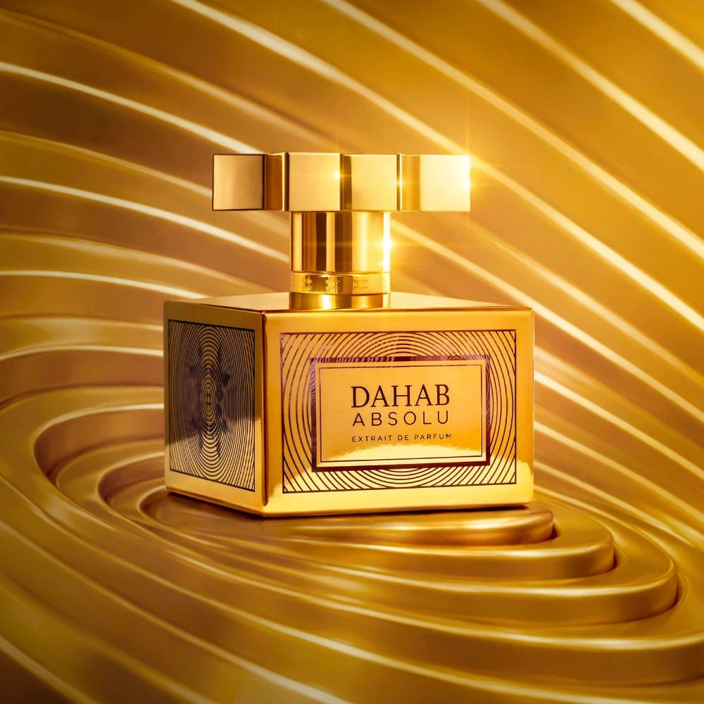 Kajal Dahab Absolu bottle on gold swirl background