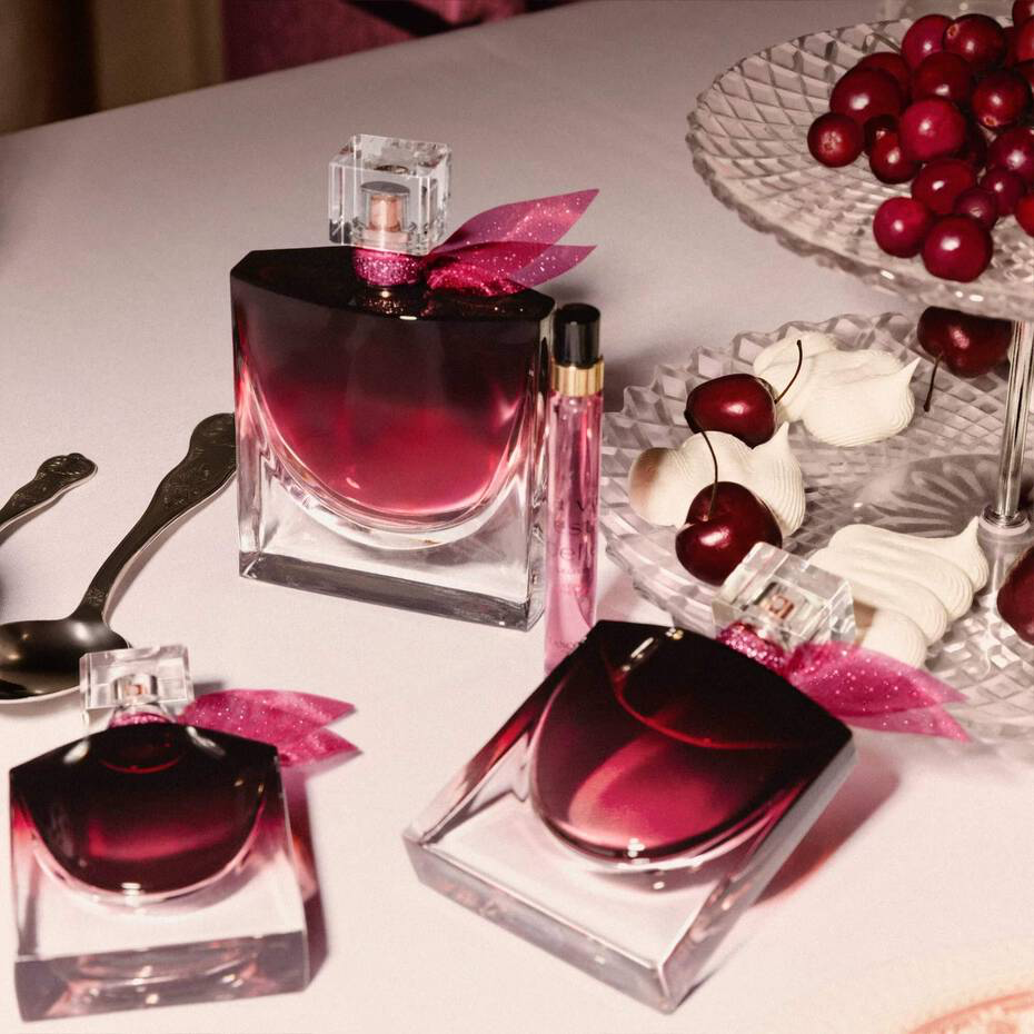 Lancôme Very Cherry bottles displayed with cherries and white meringues
