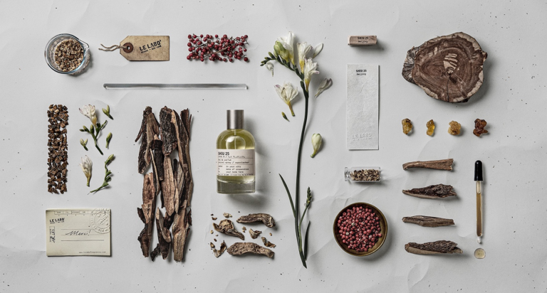Le Labo Shiu 25 Beijing City Exclusive bottle surrounded by woods, flowers and aromatic materials.