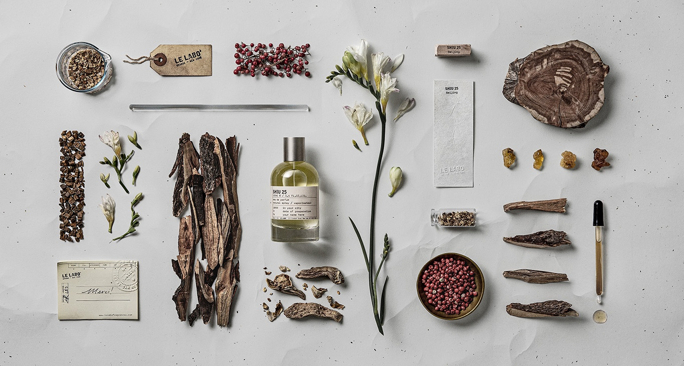 Le Labo Shiu 25 Beijing City Exclusive bottle surrounded by woods, flowers and aromatic materials.