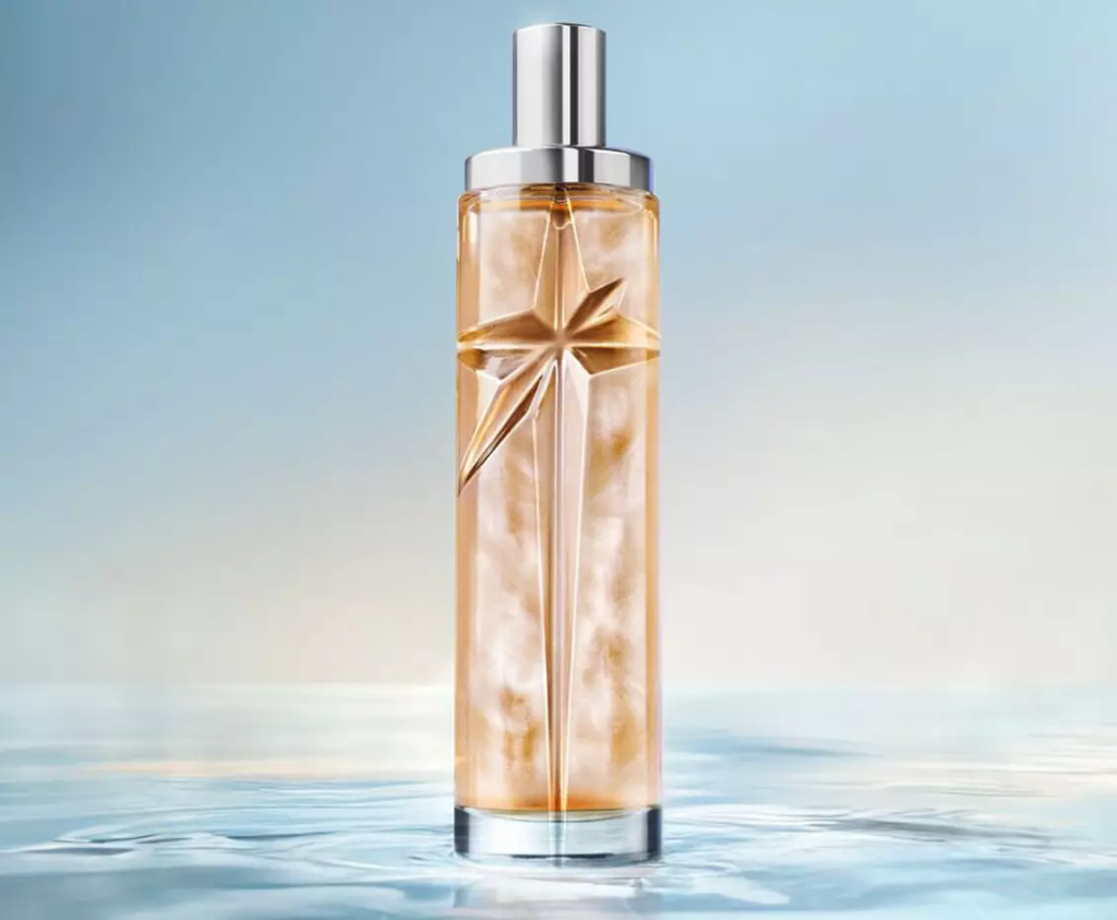 Mugler Starlicious Pineapple Musk 75 ml bottle on a pale blue water background