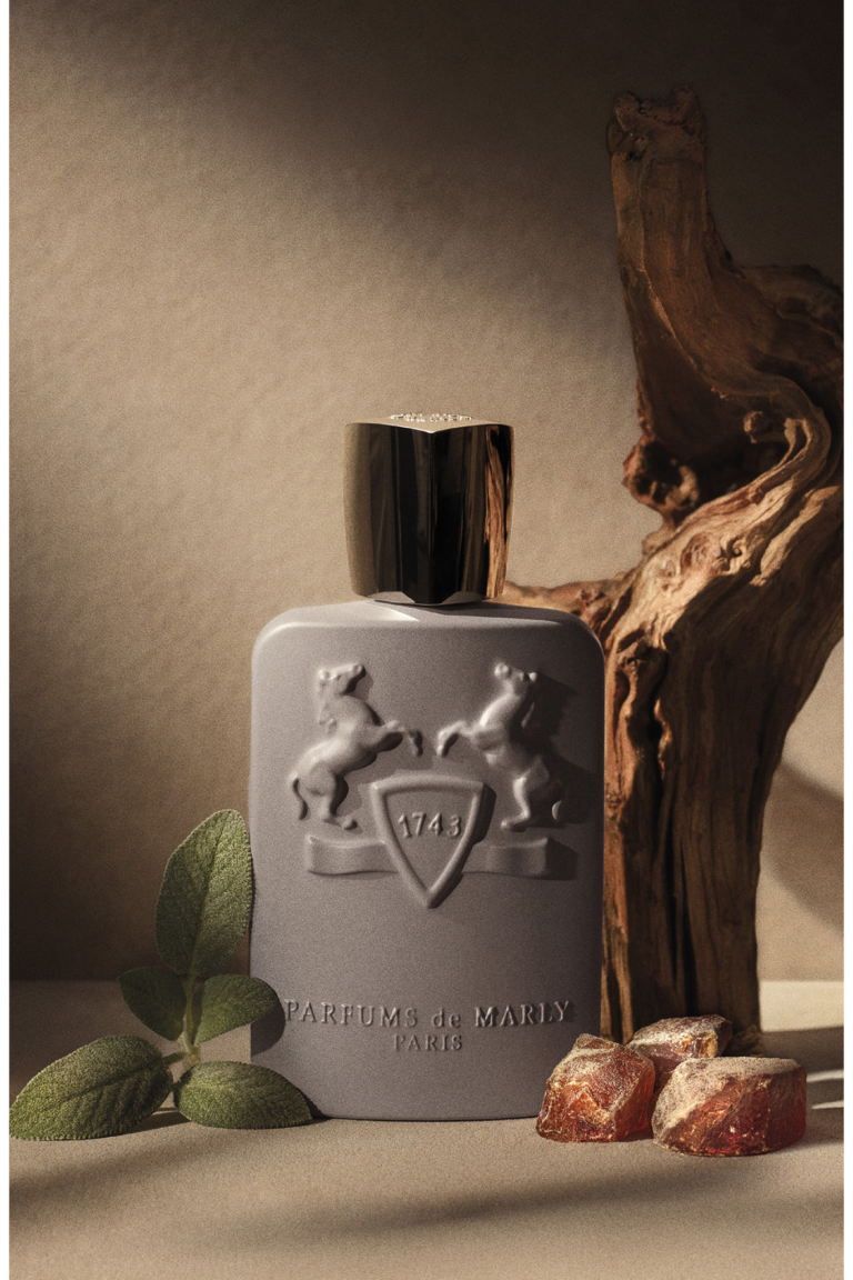 Parfums de Marly Dorval grey bottle with resin, wood and green leaves