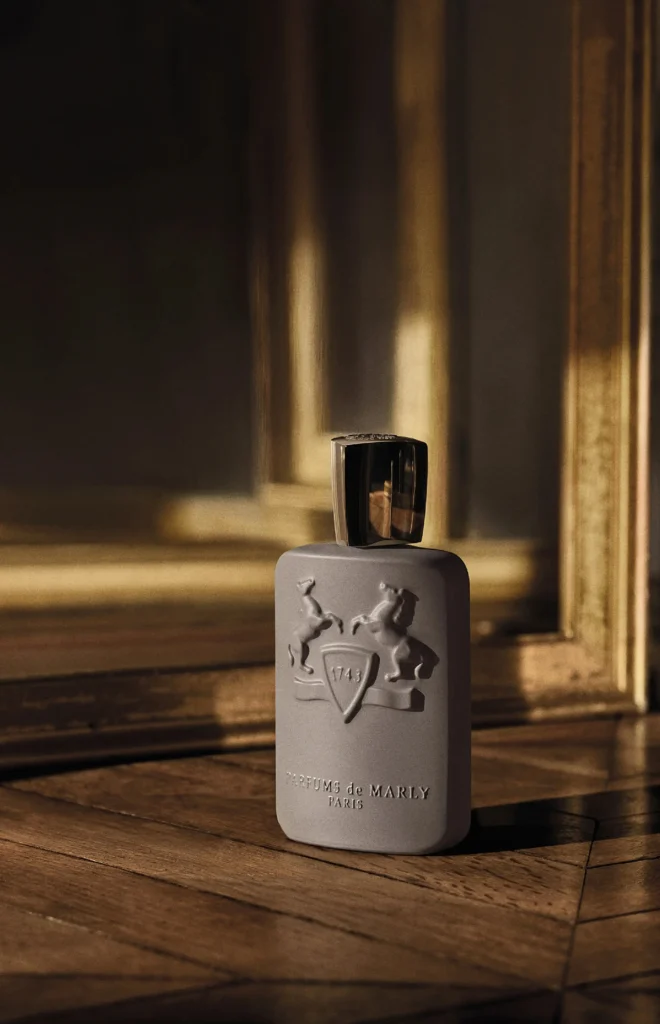 Parfums de Marly Dorval grey Eau de Parfum bottle in a dark gilded room