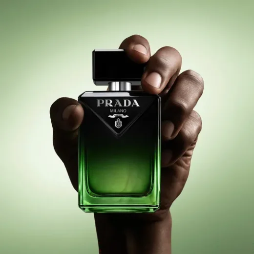 Hand holding a bottle of Prada Paradigme Le Parfum