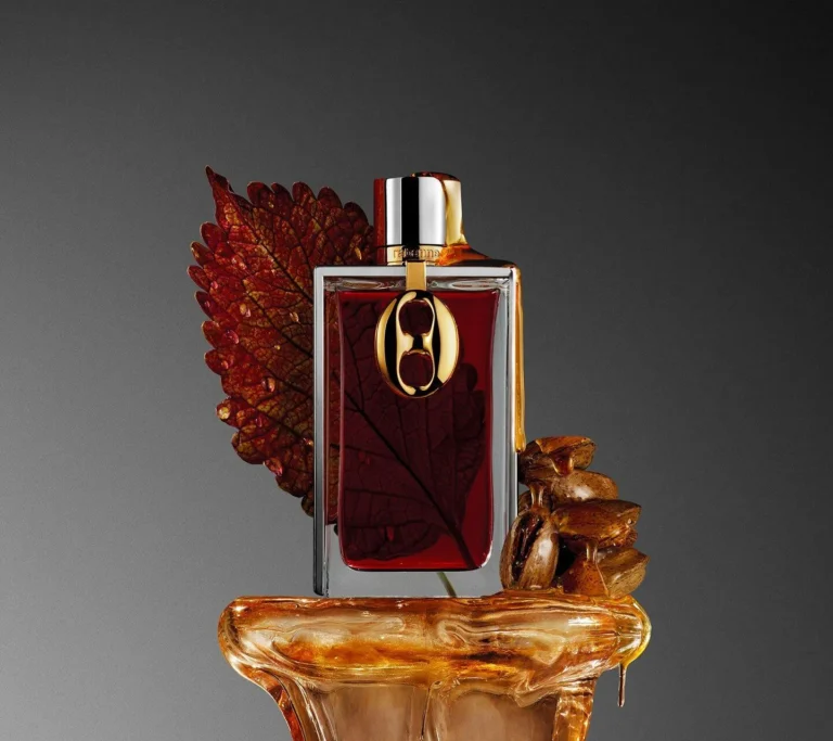 Rabanne Brutalist Amber 2026 displayed with amber resin and a dark red leaf