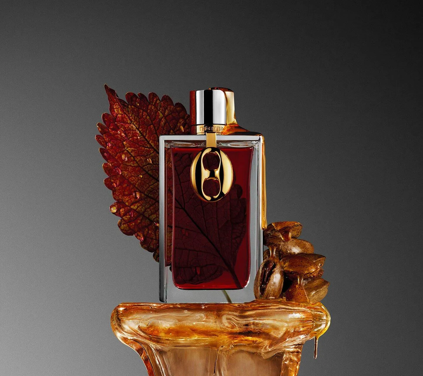 Rabanne Brutalist Amber 2026 displayed with amber resin and a dark red leaf