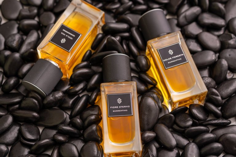 Sorrentino Perfumes collection with Fiore Eterno, Isola Mia and Dolce Foresta bottles on black stones