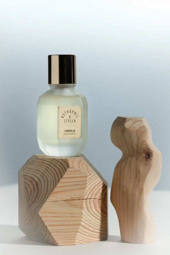 Astrophil & Stella Sambalia bottle displayed with wooden sculptures