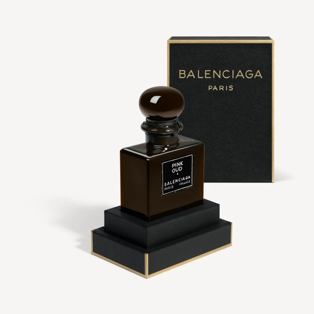 Balenciaga Pink Oud bottle in front of its black presentation box.