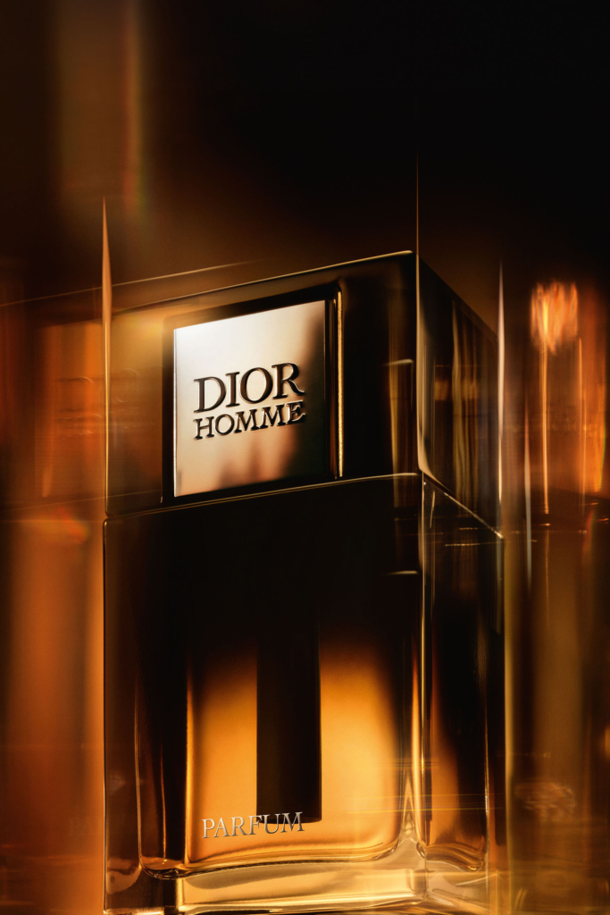 Dior Homme Parfum bottle illuminated by amber light