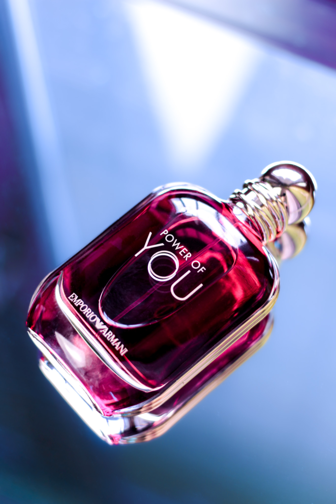 Emporio Armani Power of You perfume bottle on a blue reflective background