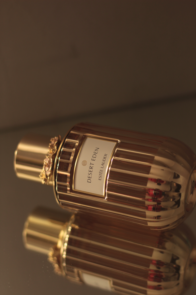 Estée Lauder Desert Eden perfume bottle with gold details and reflective glass