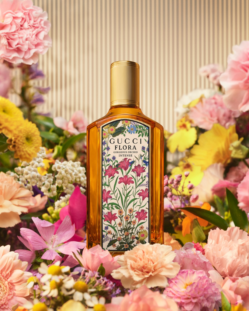 Gucci Flora Gorgeous Orchid Intense bottle surrounded by pink and yellow flowers