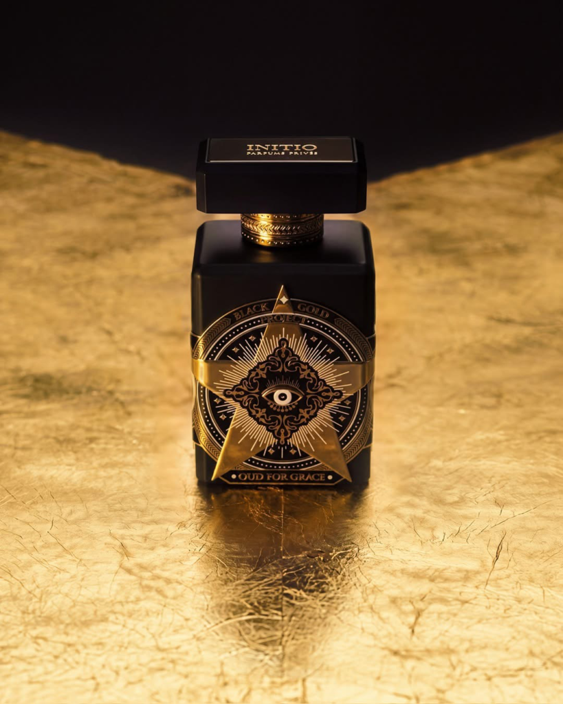 Initio Oud for Grace bottle displayed on a textured gold surface
