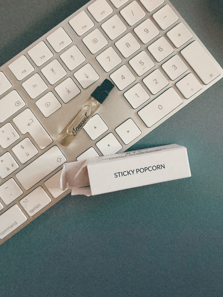 Jousset Sticky Popcorn sample used for the fragrance review beside a computer keyboard