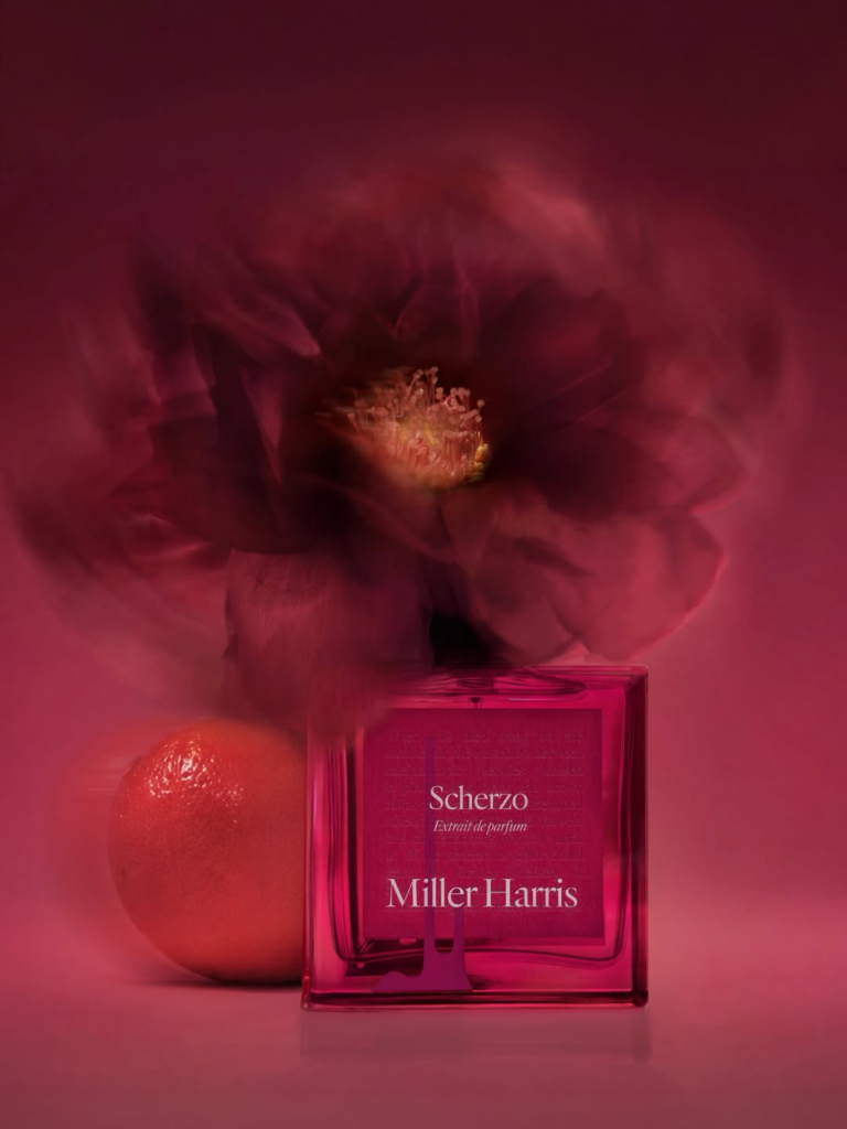 Miller Harris Scherzo Extrait perfume bottle in a crimson floral setting