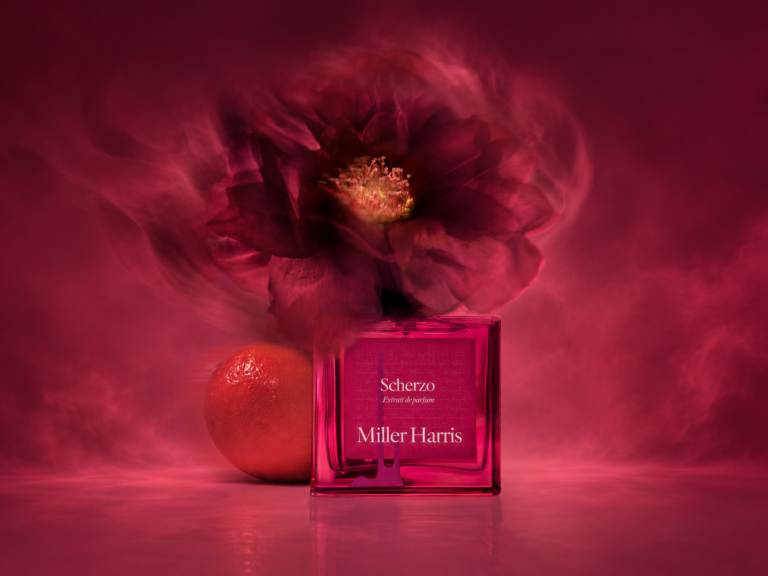 Miller Harris Scherzo Extrait perfume bottle in a deep crimson floral setting
