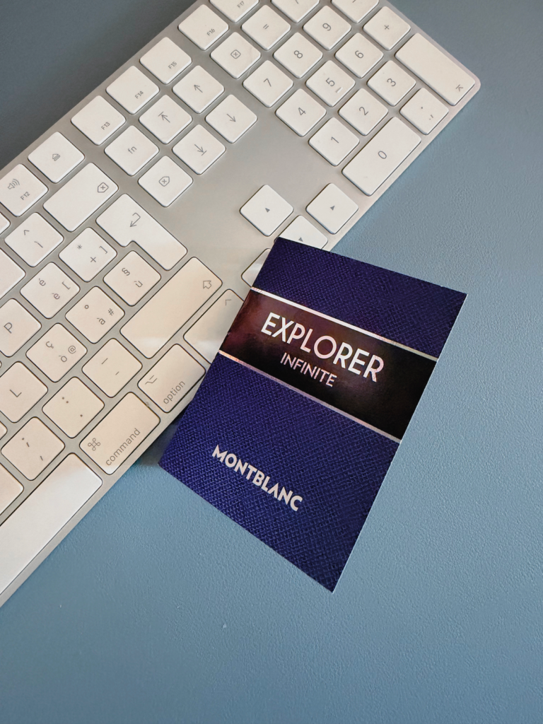 Montblanc Explorer Infinite sample card beside a computer keyboard