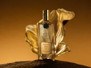 Nicolaï Patchouli Spirit Eau de Parfum Intense bottle with a golden leaf and dark earth