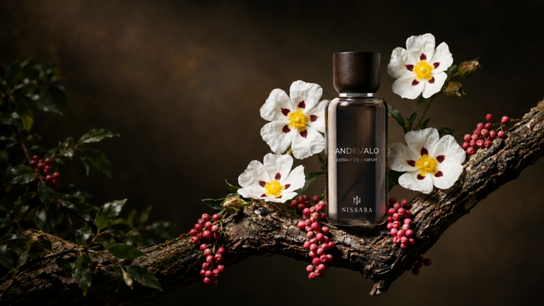 Nissaba Andevalo perfume bottle surrounded by white cistus flowers and red berries