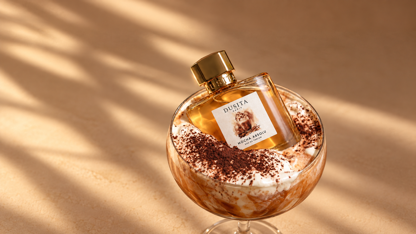 Mocha Absolu perfume bottle resting in a cocoa-dusted dessert glass
