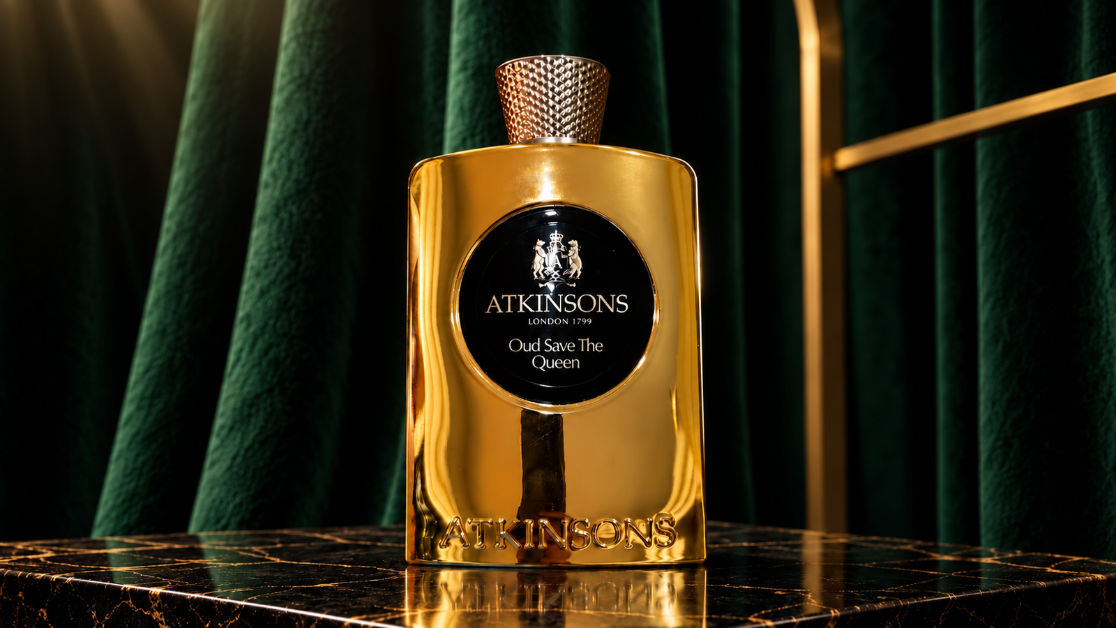 Atkinsons Oud Save the Queen gold perfume bottle against dark green velvet