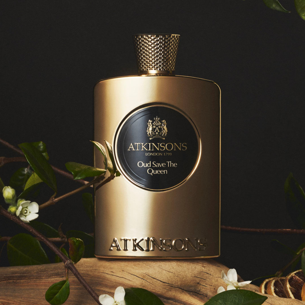 Atkinsons Oud Save the Queen perfume bottle surrounded by white flowers