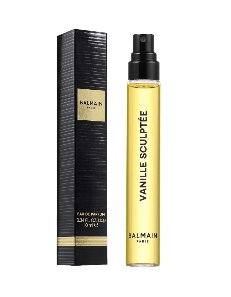 Balmain Vanille Sculptée 10 ml travel spray beside its black and gold box on a white background