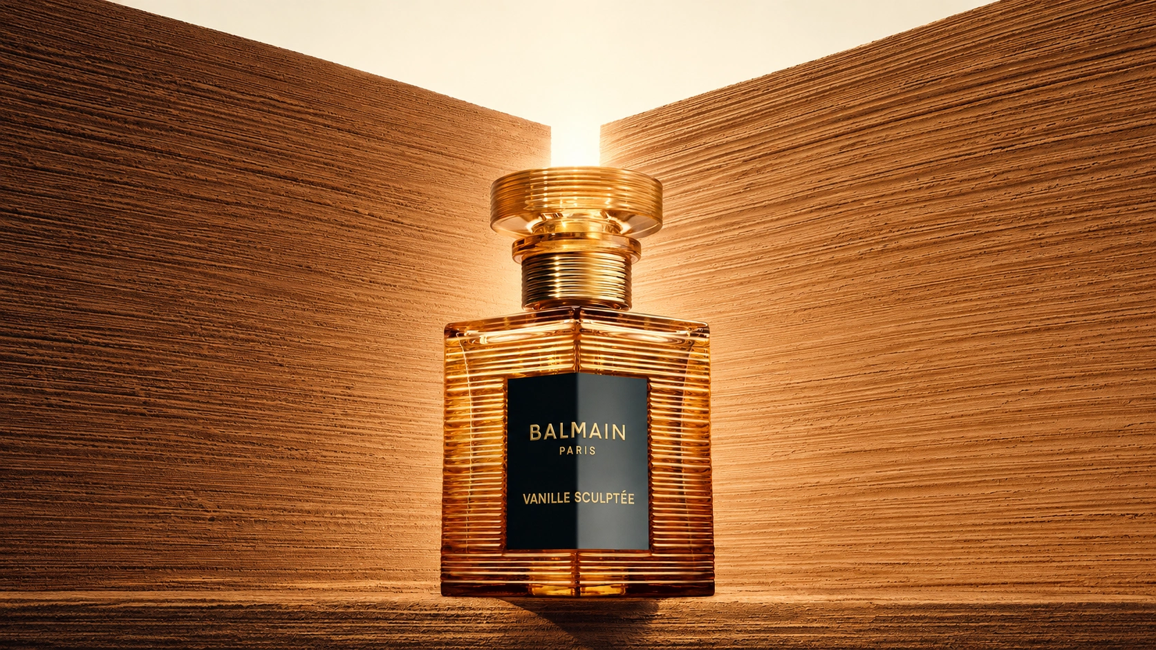 Balmain Vanille Sculptée bottle centred between textured golden walls in warm backlighting